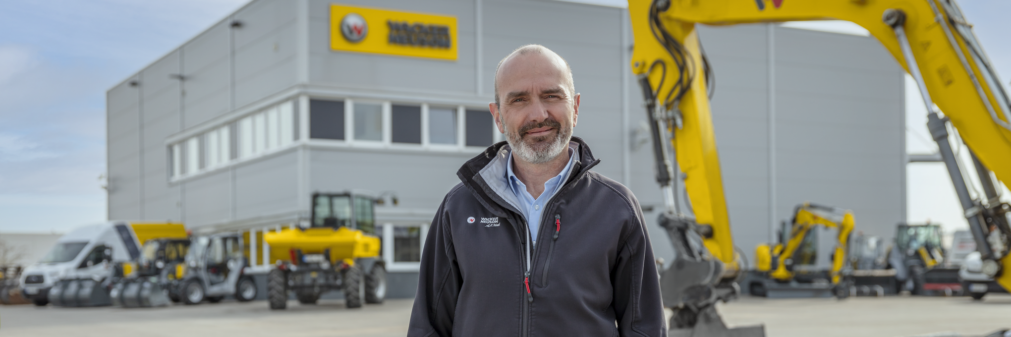 Wacker Neuson employee standing in front of Wacker Neuson rental station.