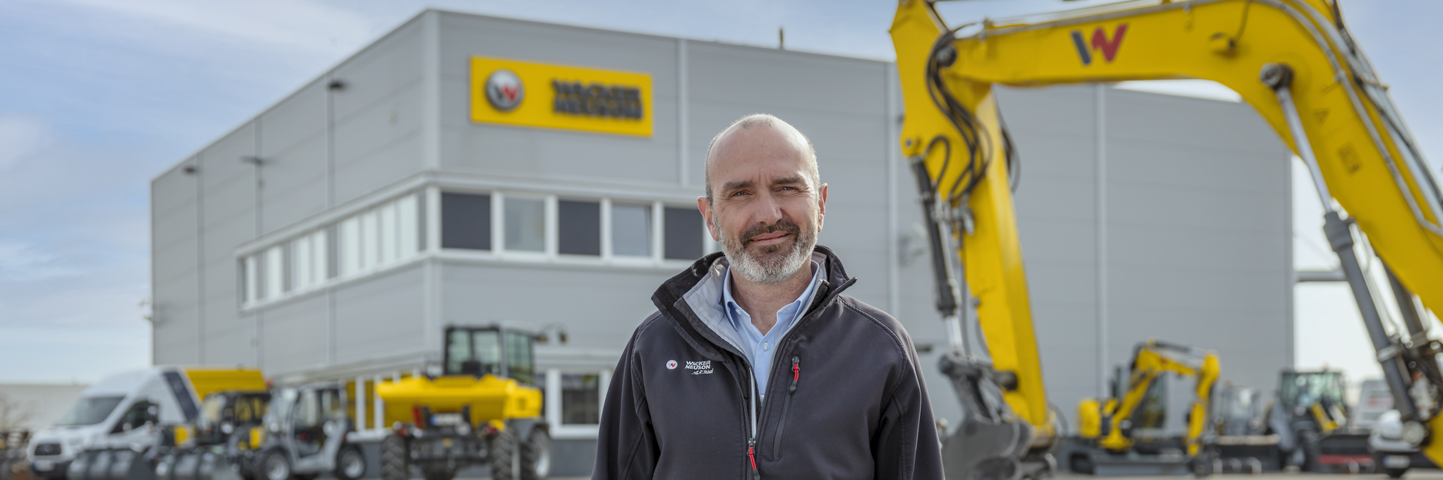 Wacker Neuson employee standing in front of Wacker Neuson rental station.