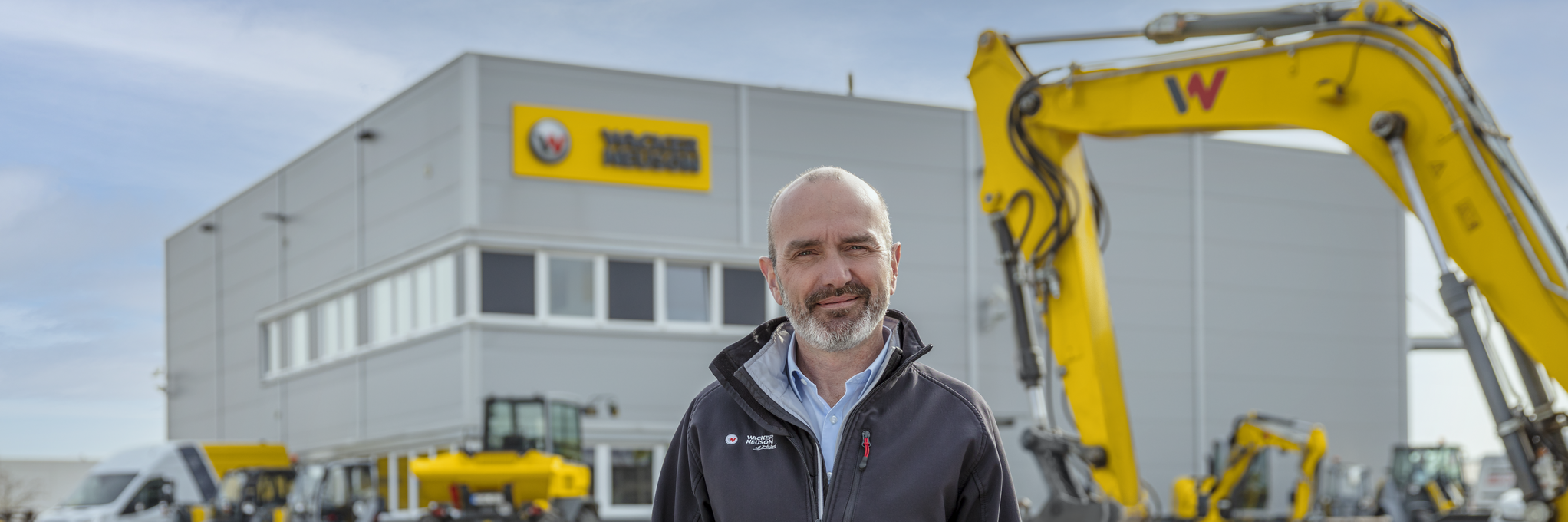 Wacker Neuson employee standing in front of Wacker Neuson rental station.