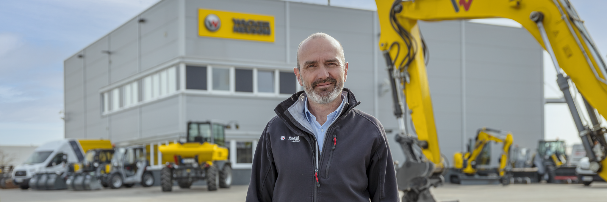 Wacker Neuson employee standing in front of Wacker Neuson rental station.