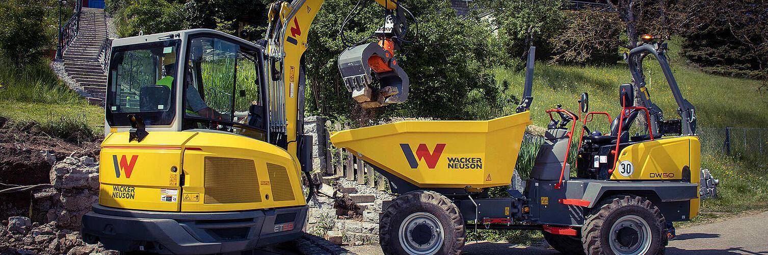 An excavator and a dumper working together