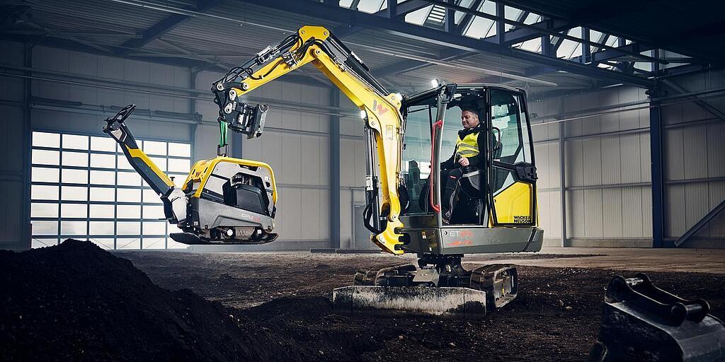 mini excavator in action in industry hall